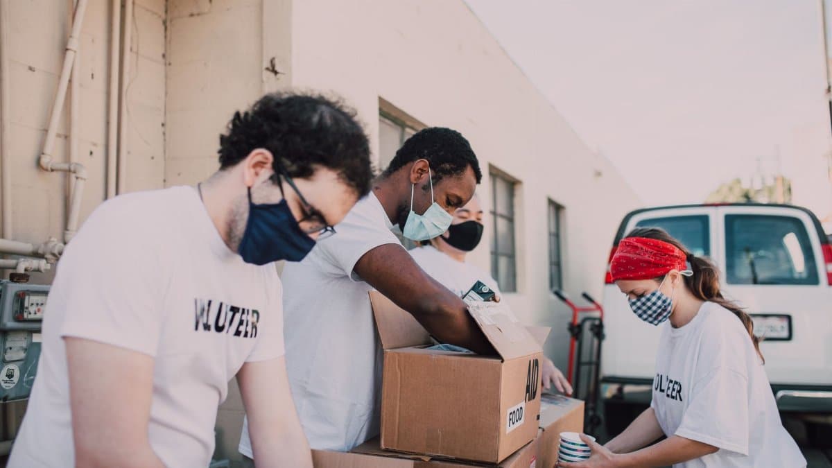 Volunteers packing food donations outdoors to support a local charity event.