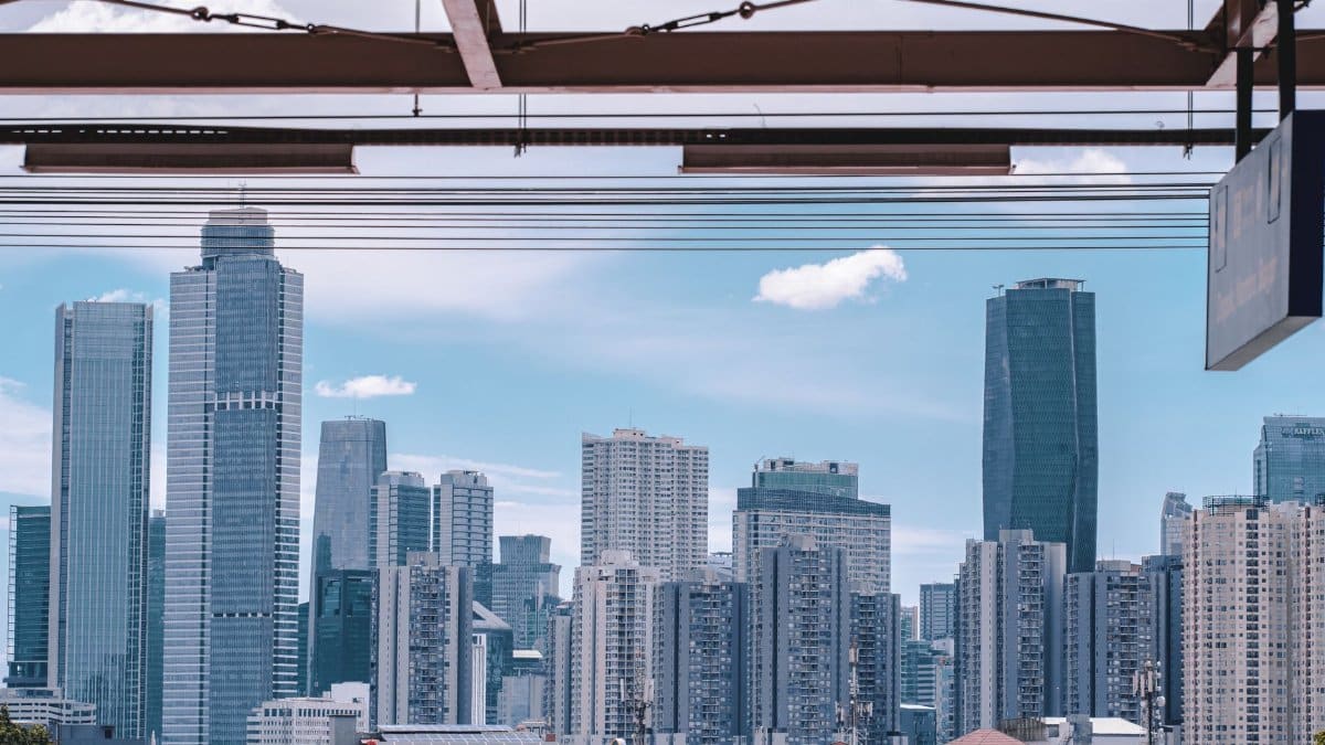View of Jakarta's urban skyline showcasing modern skyscrapers under a clear blue sky.