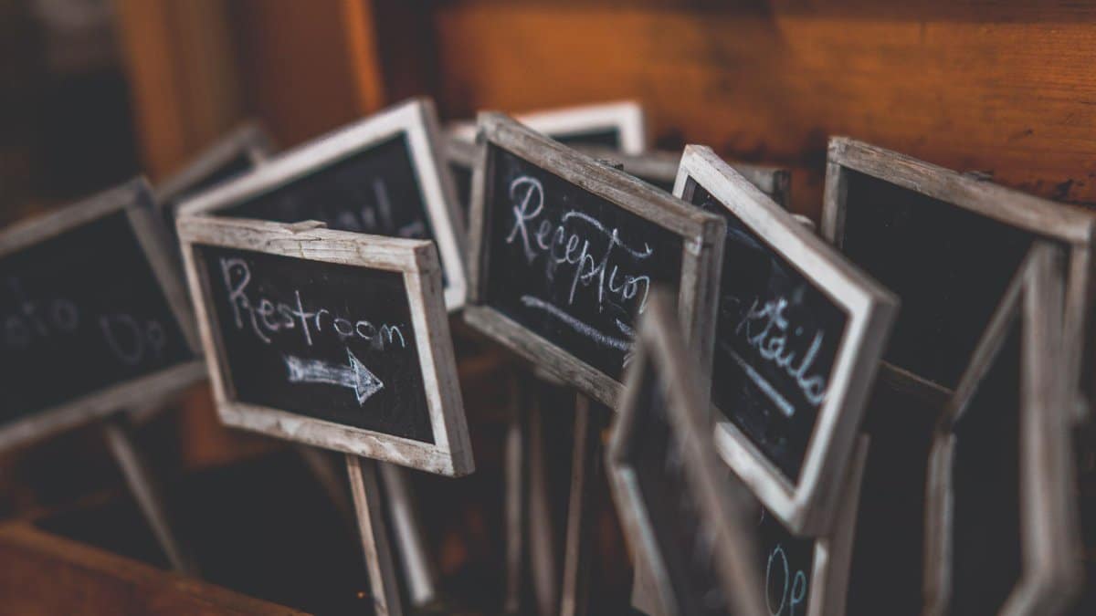 Rustic collection of small chalkboard signs used for event directions and labeling.