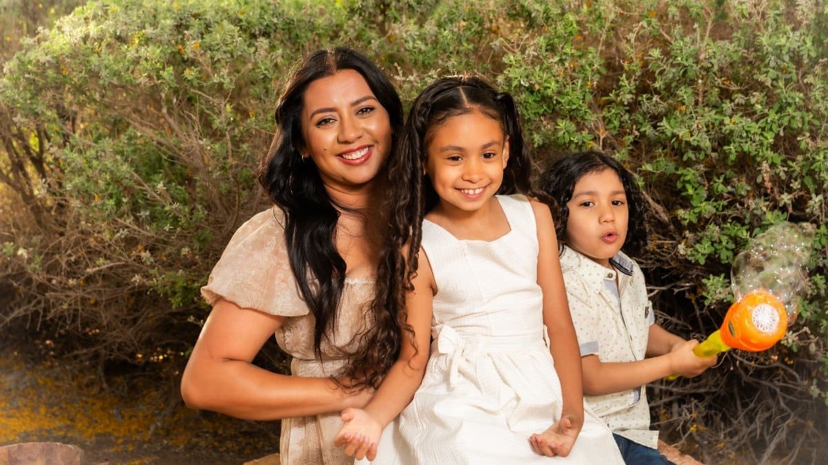 A joyful family of three spending time together outdoors in Lubbock, Texas.