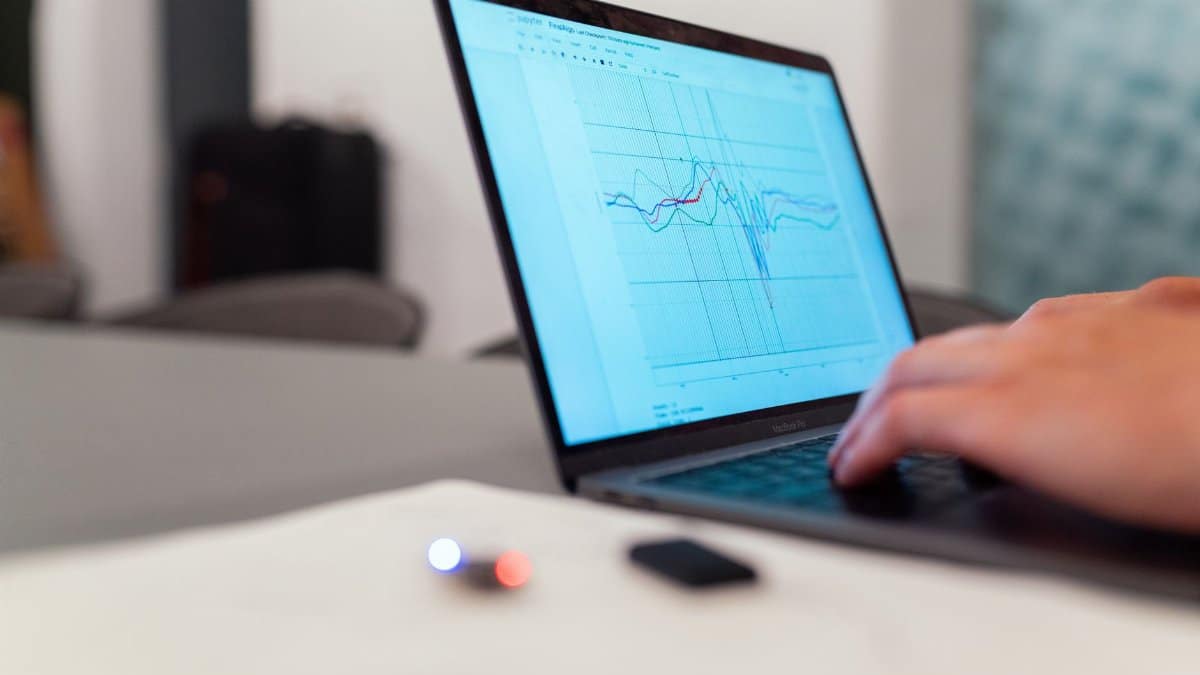 A person working on a graph analysis on a laptop for data monitoring and research.