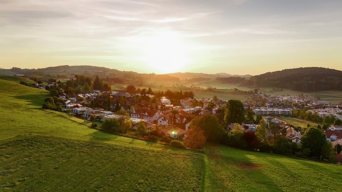 Beautiful aerial view of Wil, Switzerland with a vibrant sunset over rolling hills.