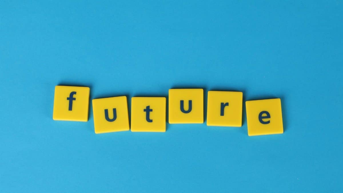 Yellow letter tiles spelling 'future' on a blue background, emphasizing creativity and optimism.