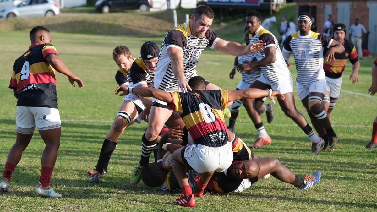Dynamic rugby game showcasing teamwork and athleticism on a sunny day in South Africa.