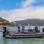 Tiburon Fire Rescue boat docked in a scenic harbor with surrounding hills.