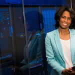 Smiling woman in data center showcasing technology expertise.