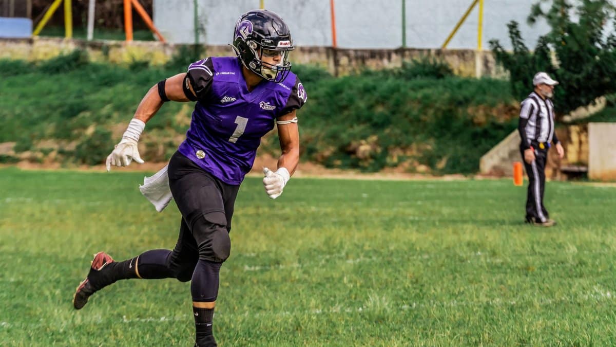 Dynamic shot of an American football player in action on the field.