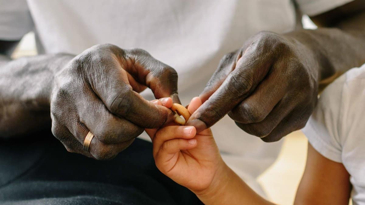 Close-up of father and child bonding through play, strengthening their relationship indoors.