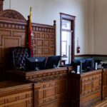 Interior view of an American courthouse in Kirksville, Missouri, featuring a judge's desk and flags.