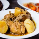 Close-up of Caribbean chicken stew with potatoes, perfect for lunch or dinner.
