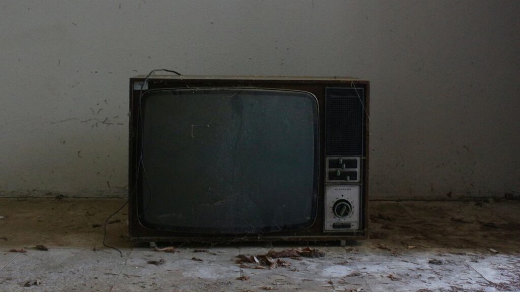 Old retro TV set in a deserted room, evoking nostalgic vibes.
