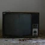 Old retro TV set in a deserted room, evoking nostalgic vibes.
