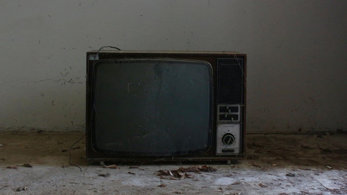 Old retro TV set in a deserted room, evoking nostalgic vibes.