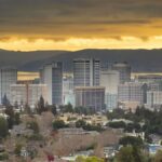 Skyline of Oakland, California at sunset with dramatic skies.