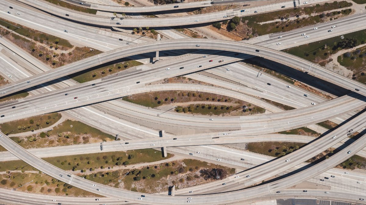 Aerial shot of sprawling highway interchange in Los Angeles with sparse traffic.