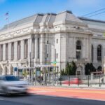 Elegant historic architecture photographed in San Francisco's Civic Center, capturing urban movement.