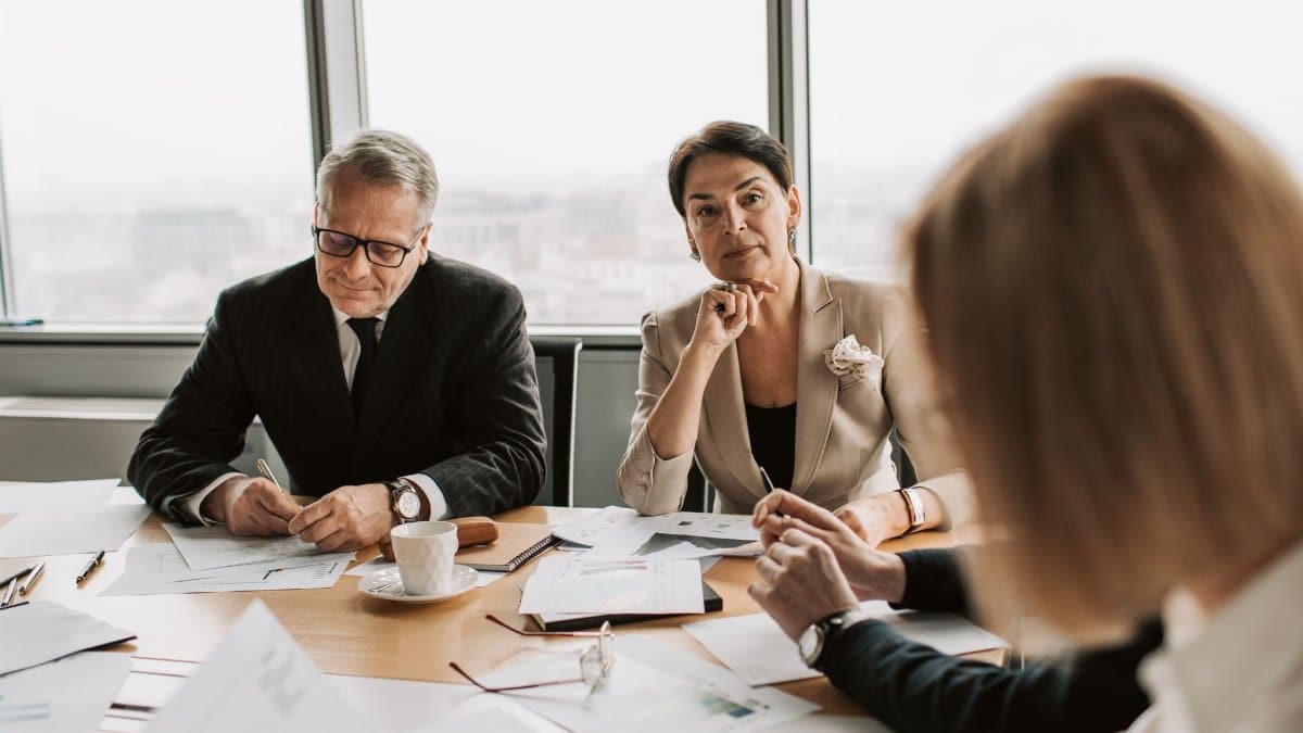 Business professionals in discussion during a meeting in a modern office setting.