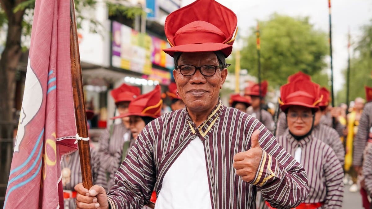 Traditional parade in Yogyakarta showcasing cultural attire and community spirit.