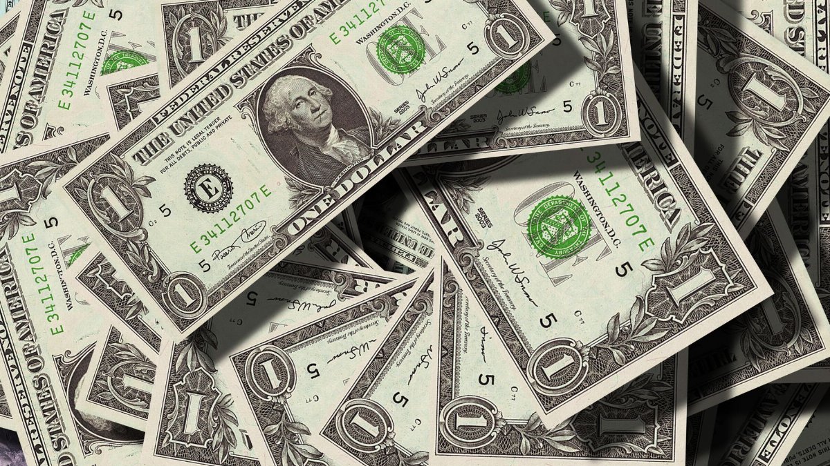 Close-up of scattered US dollar bills symbolizing finance and wealth.