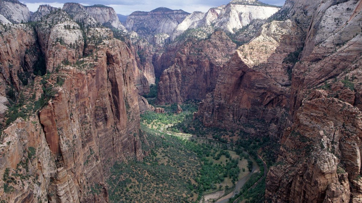 Majestic aerial shot of rocky cliffs and valley in Zion National Park, showcasing its natural beauty.
