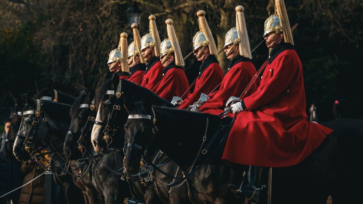 Ceremonial horse guard parade in London, England showcasing traditional British uniforms and horses.
