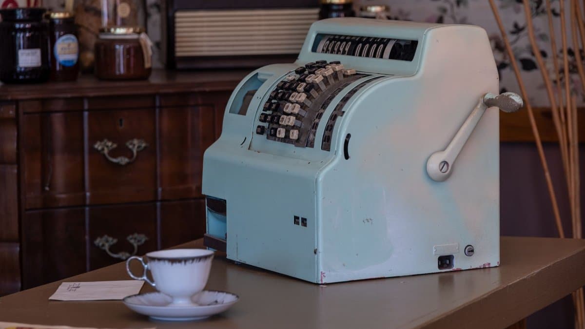 Explore the charm of a vintage cash register in a classic retail setting with retro decor.
