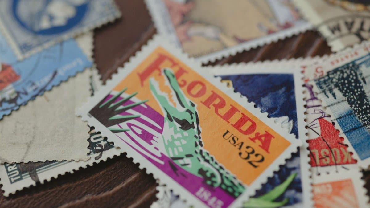 Close-up of diverse vintage stamps, featuring a Florida stamp. Captures postal history and design art.