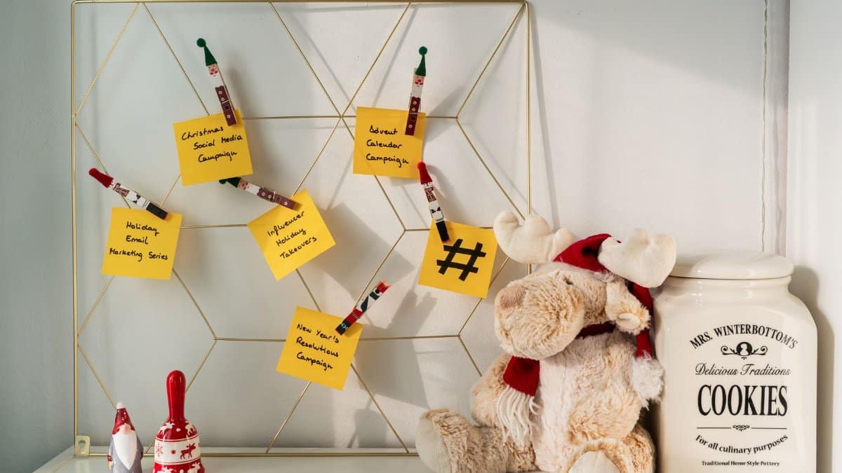 A cozy desk with holiday decorations, notes, and a cookie jar, conveying a festive atmosphere.