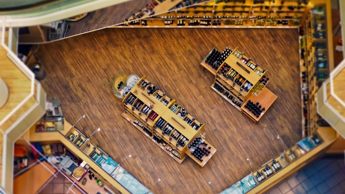 Explore the stylish interior of a contemporary liquor store with wooden shelves and a wide selection of beverages.