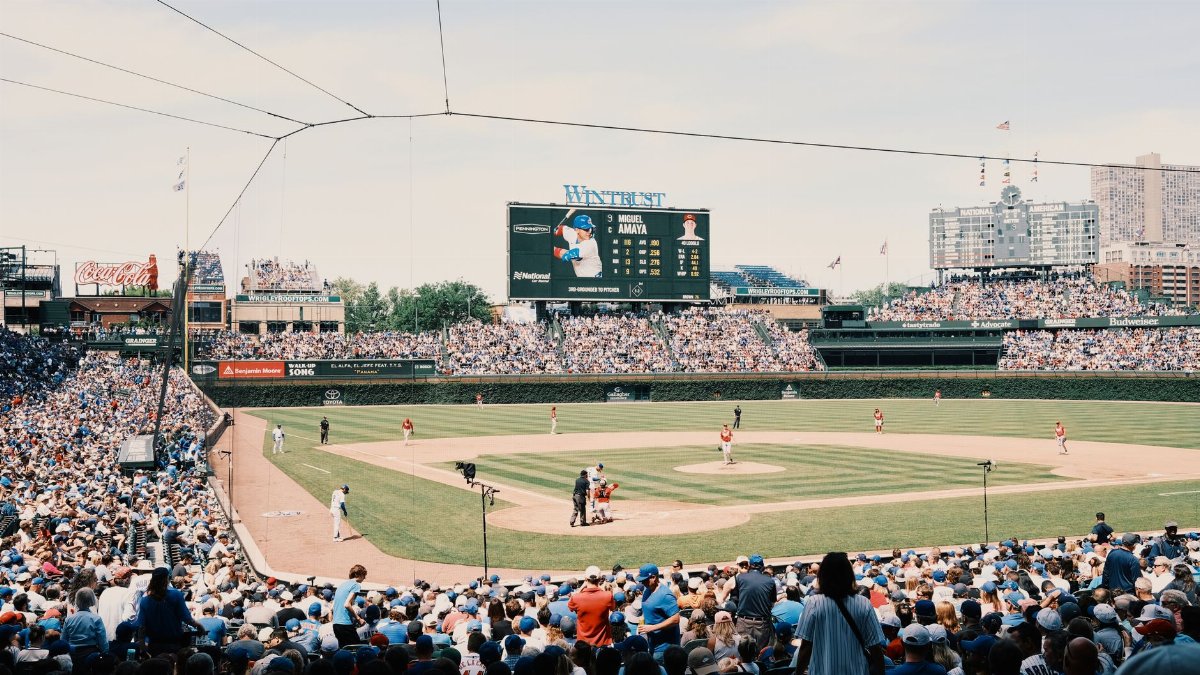 A lively baseball game at Wrigley Field with a packed stadium and urban skyline.