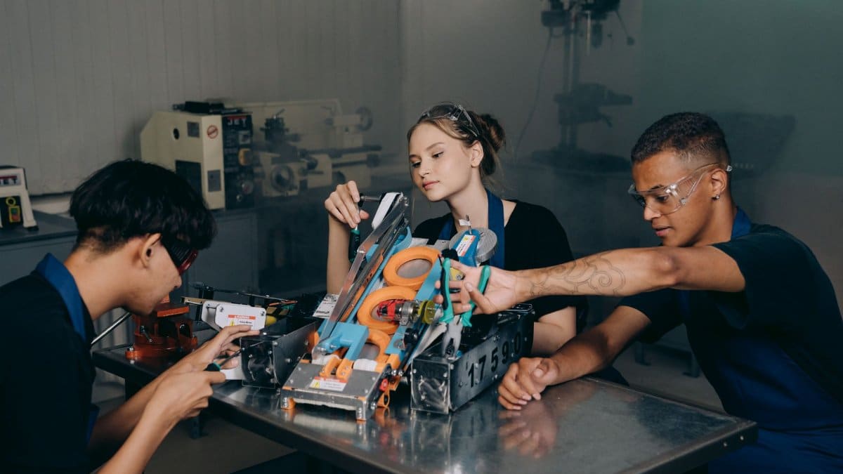 Students engaged in assembling a robotics project in an educational lab setting.