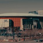 A daylight view of Ball Arena amidst Denver's urban landscape, highlighting its architectural design.