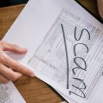 Documents highlighting tax fraud with the word 'scam' on tax forms.