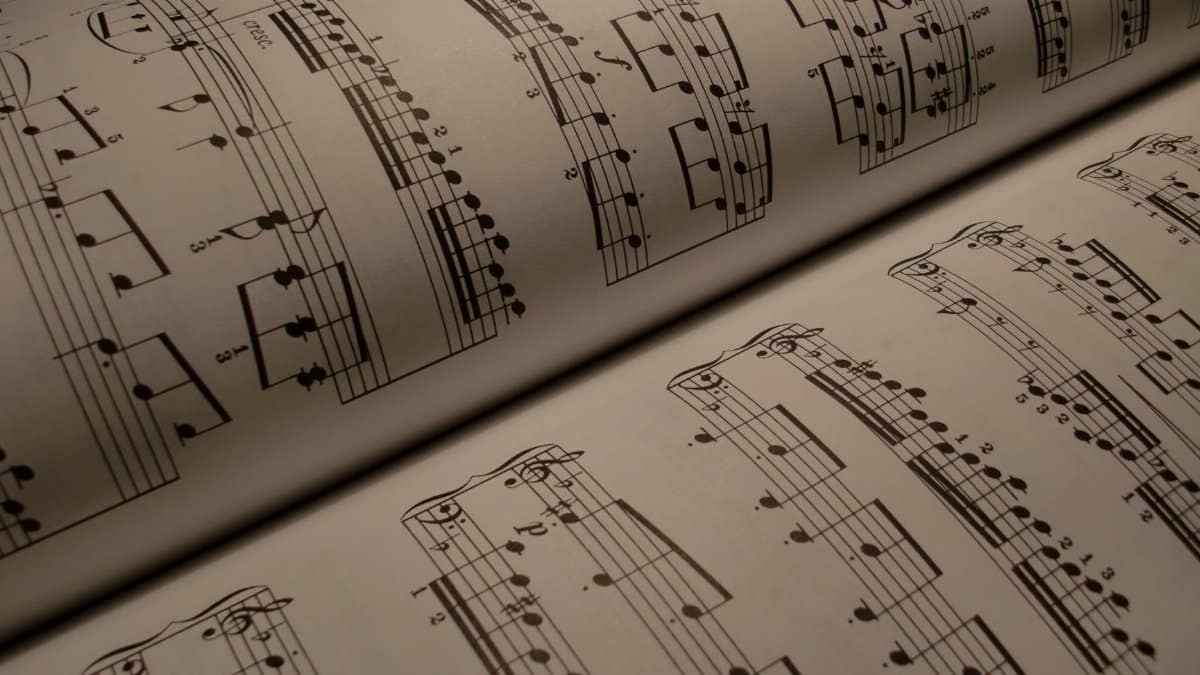 Detailed view of an open music book displaying musical notes and sheet music.