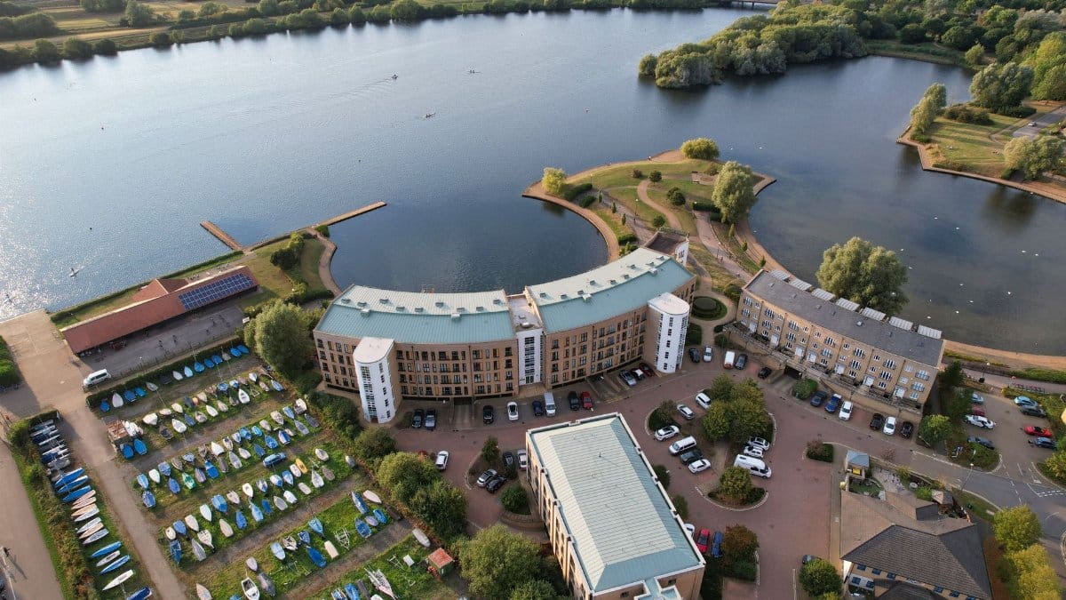 Aerial view of Caldecotte's lakeside buildings and marina in England.