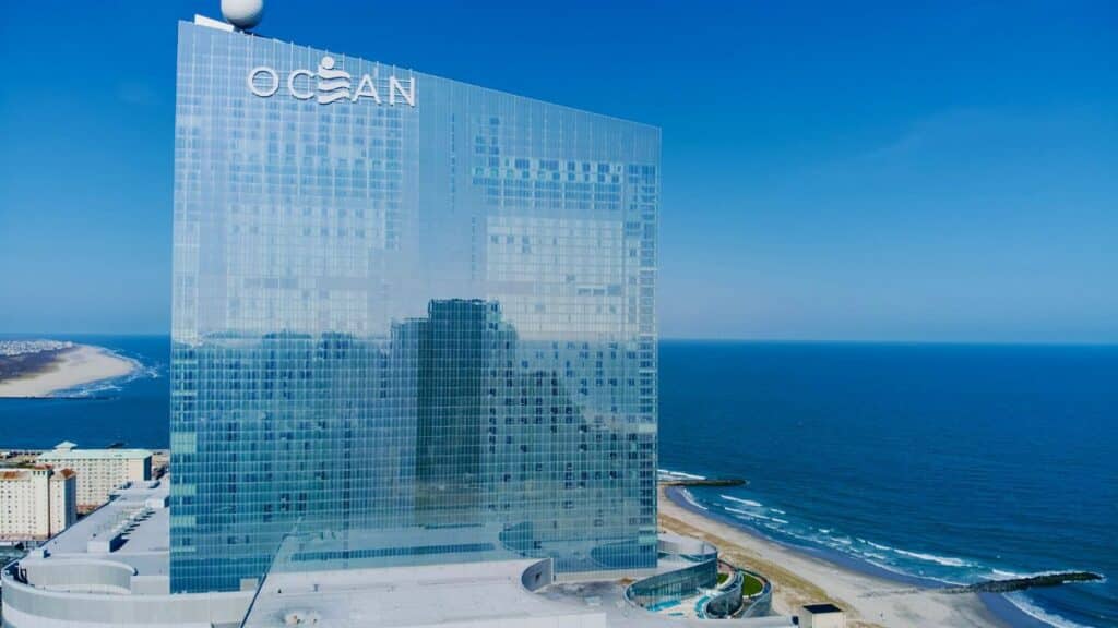 Aerial view of Ocean Casino Resort in Atlantic City with coastline and ocean reflections.
