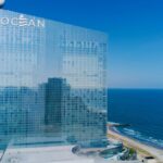 Aerial view of Ocean Casino Resort in Atlantic City with coastline and ocean reflections.