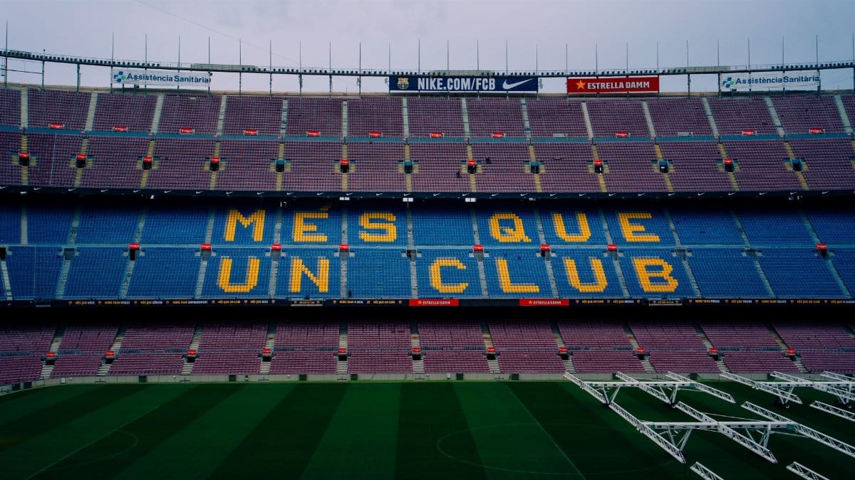View of Camp Nou stadium seating displaying 'Mes Que Un Club' in Barcelona, Spain.