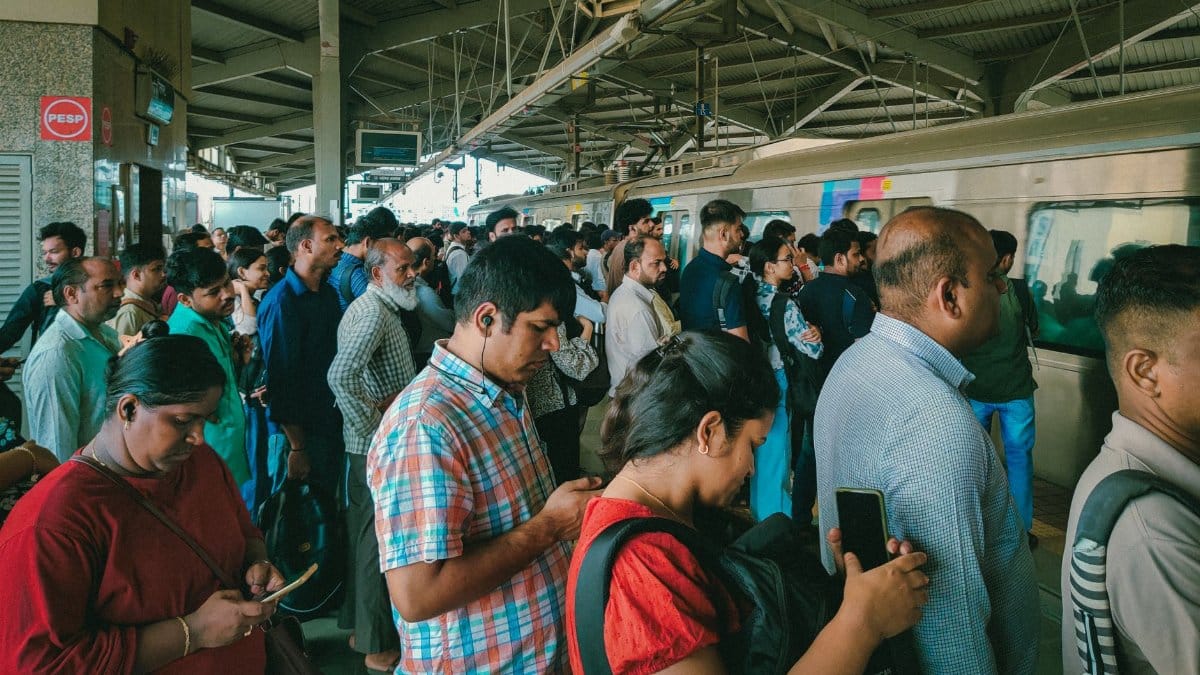 A bustling scene of commuters waiting on a Mumbai train station platform. Captures Mumbai's daily life.
