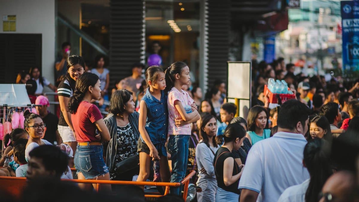 A lively scene of people gathering at a street festival, showcasing cultural diversity and community spirit.