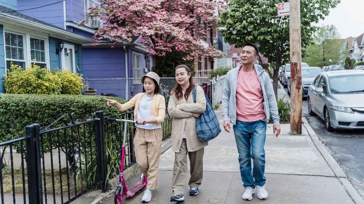 Family walking together on a pleasant day in a vibrant urban neighborhood.
