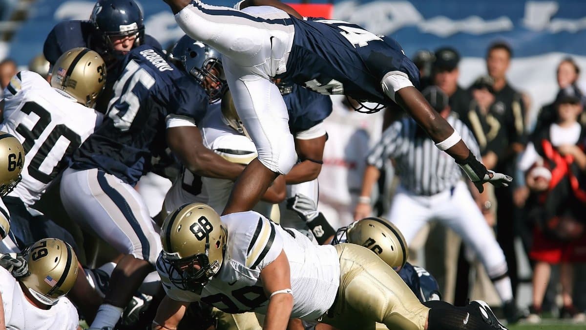 Dynamic action shot capturing athletes competing in an American football game.