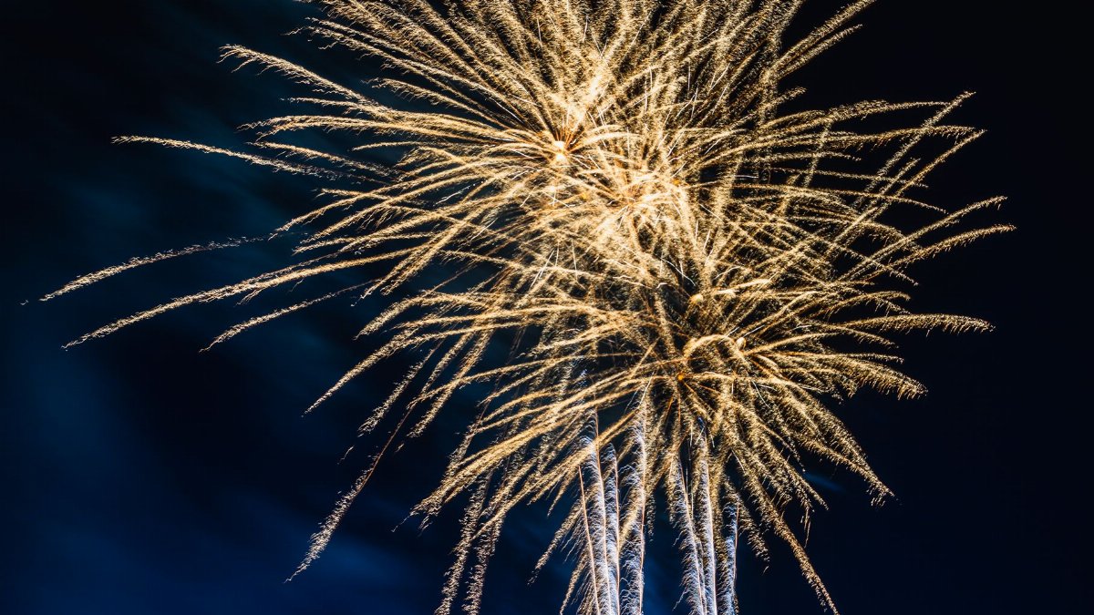 Golden fireworks illuminating the night sky, perfect for festive celebrations.