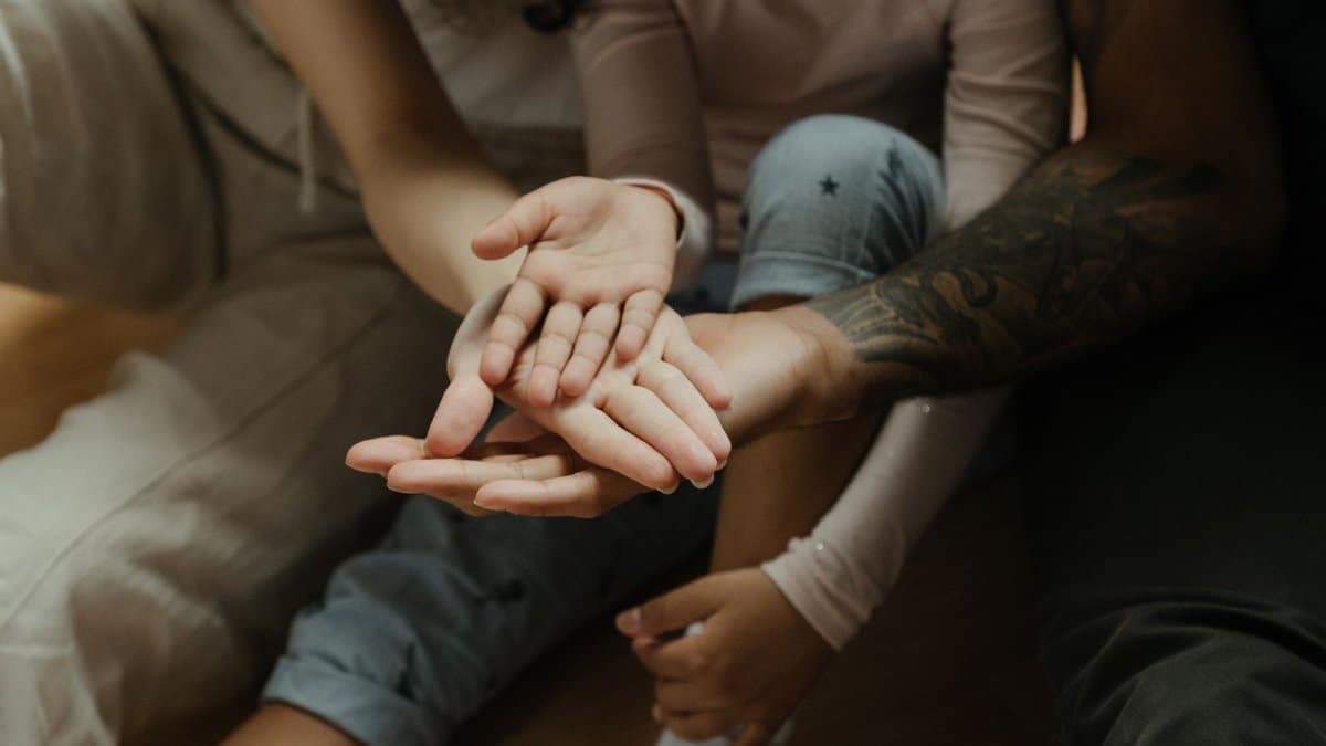 Close-up of diverse family hands symbolizing connection and warmth.