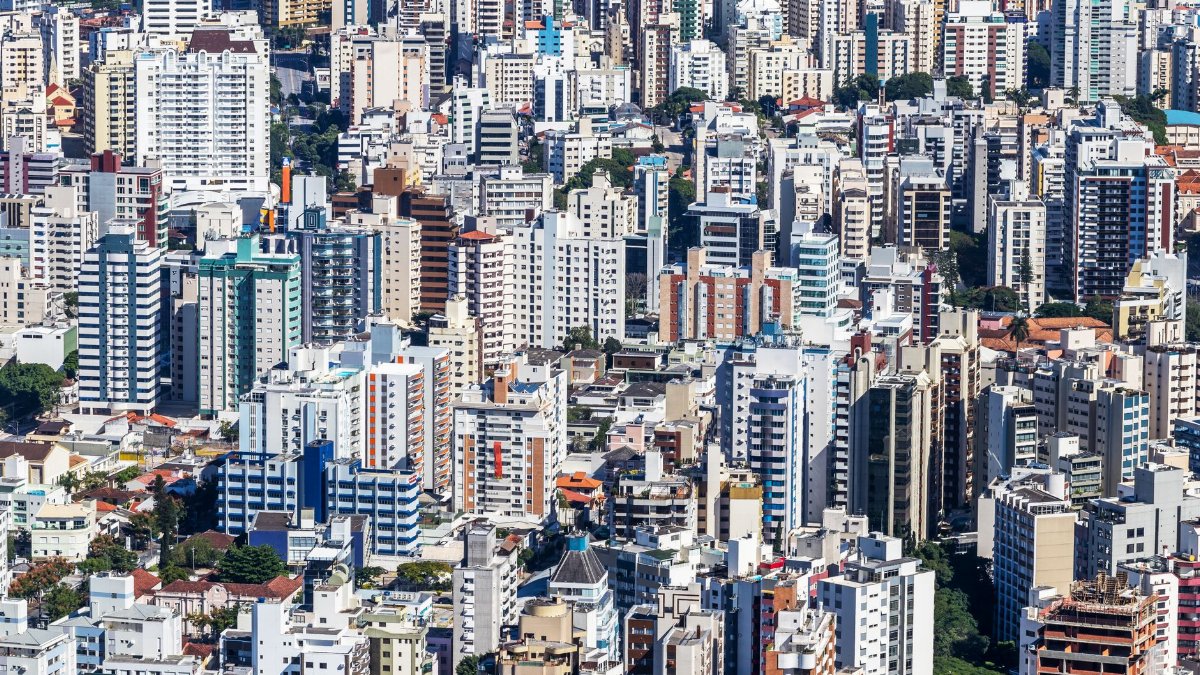 A vibrant aerial view of a densely packed urban cityscape with numerous skyscrapers.