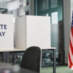 Voting booths with an American flag in an office, symbolizing Election Day.