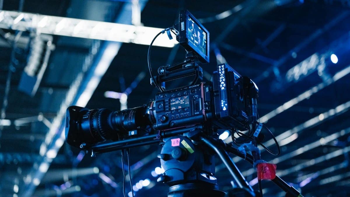 Close-up of professional video camera setup in a well-lit indoor event venue.