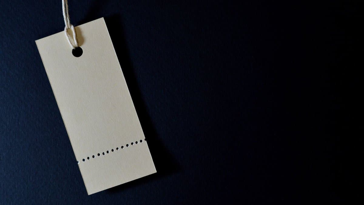 Elegant minimalist card with a string, ideal for labeling or pricing against a black background.