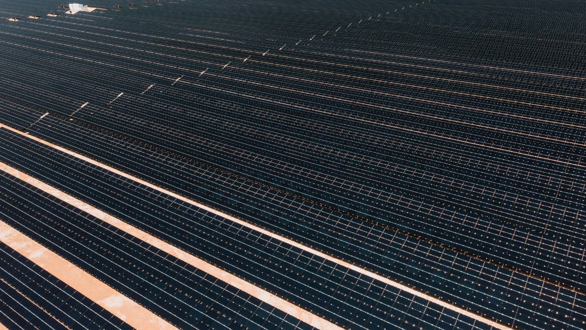 A vast array of solar panels in a solar farm, illustrating renewable energy and sustainability.