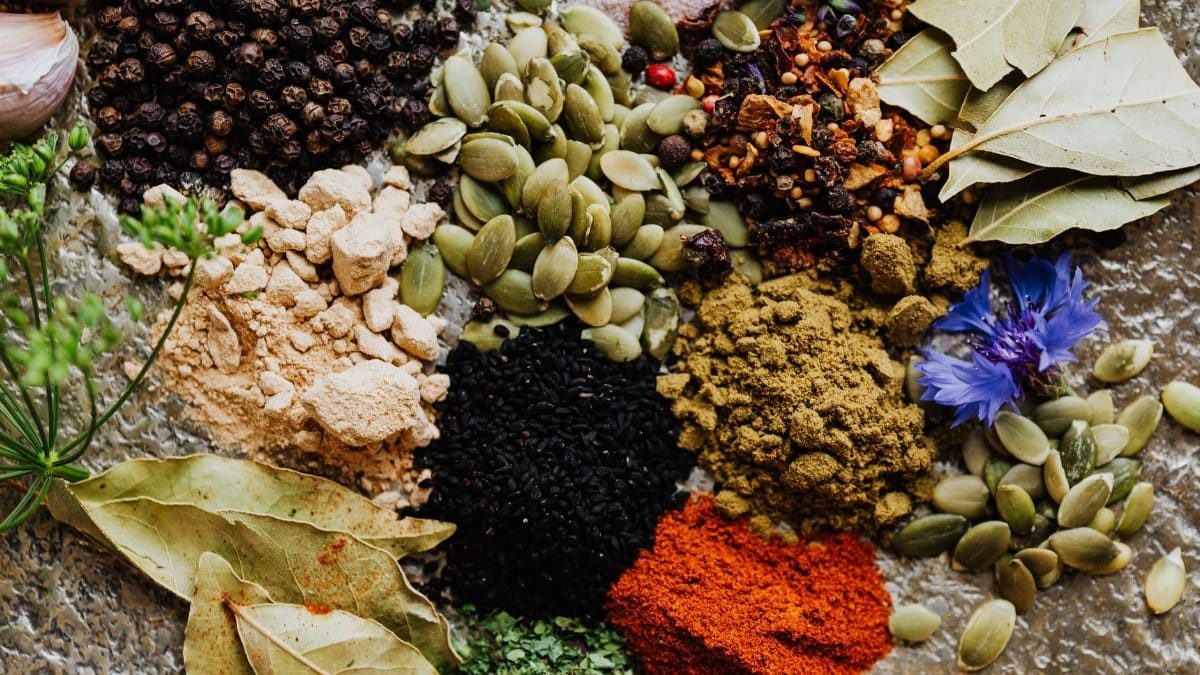High-quality flat lay of various spices and herbs, perfect for culinary arts or food blogging.